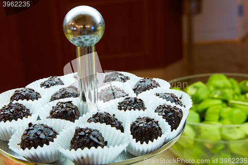 Image of Dessert table for party. akes and sweetness. Shallow dof