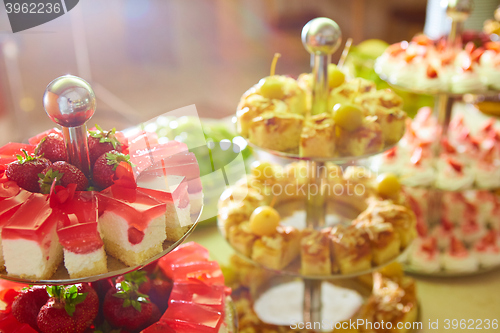 Image of Dessert table for party. akes and sweetness. Shallow dof