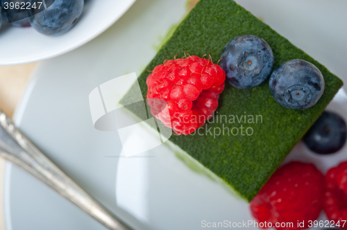 Image of green tea matcha mousse cake with berries