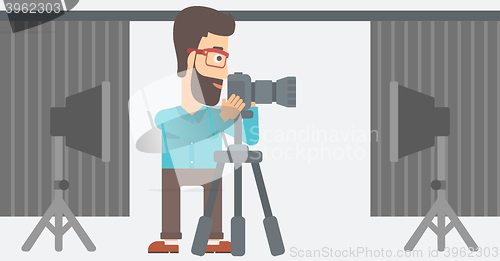 Image of Photographer working with camera on a tripod.