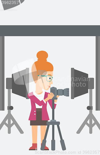 Image of Photographer working with camera on a tripod.