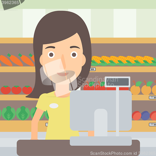 Image of Saleslady standing at checkout.