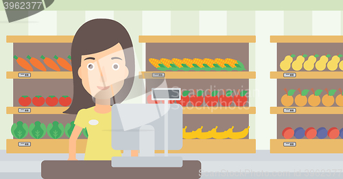 Image of Saleslady standing at checkout.