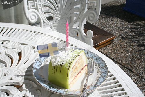 Image of Pastry with marzipan, flag and candle on top