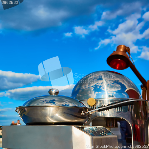 Image of Table with dishware and marmites waiting for guests.