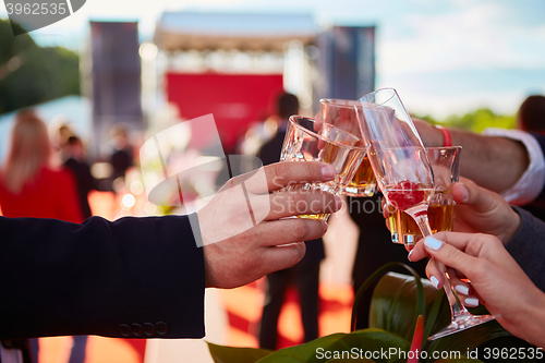 Image of ringing filled the four glasses of champagne