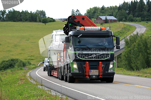 Image of Volvo FM Semi Boat Transport on Rural Road