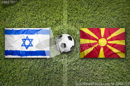 Image of Israel vs. Macedonia flags on soccer field