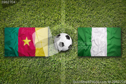 Image of Cameroon vs. Nigeria flags on soccer field