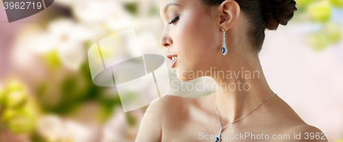 Image of beautiful asian woman with earring and pendant