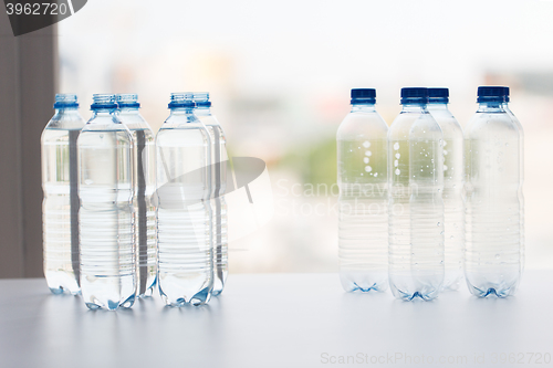 Image of close up of bottles with drinking water on table