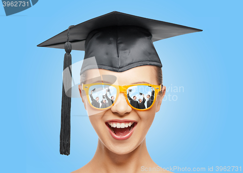 Image of happy teenage girl in shades and mortarboard hat