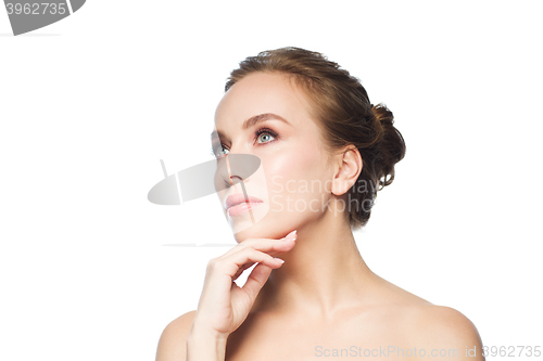 Image of beautiful young woman touching her face