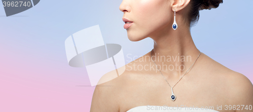 Image of close up of woman with earring and pendant