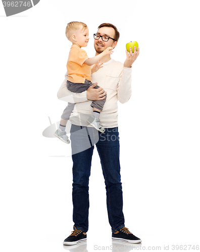 Image of happy father and little son with green apple