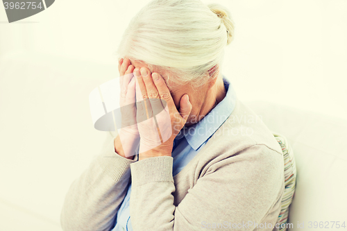 Image of senior woman suffering from headache or grief