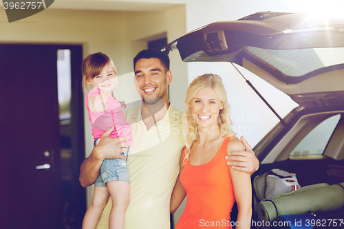 Image of happy family with hatchback car at home parking