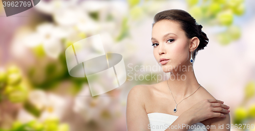 Image of beautiful asian woman with earring and pendant