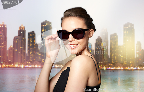 Image of beautiful young woman in elegant black sunglasses