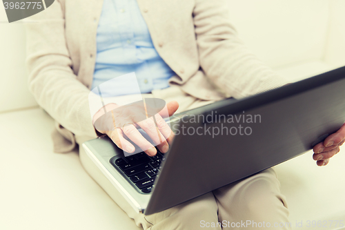 Image of close up of senior woman with laptop at home