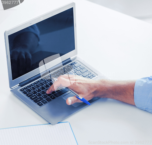 Image of miling businessman working in office