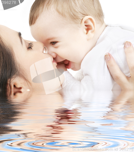 Image of happy mother kissing baby boy in water