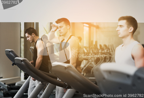 Image of group of men exercising on treadmill in gym