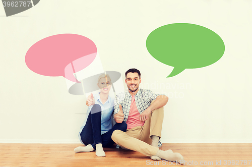 Image of happy couple showing thumbs up at new home