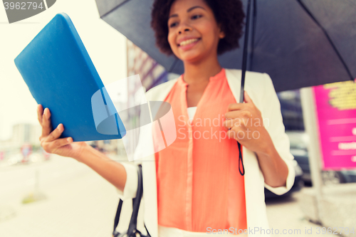 Image of close up of woman with umbrella and tablet pc