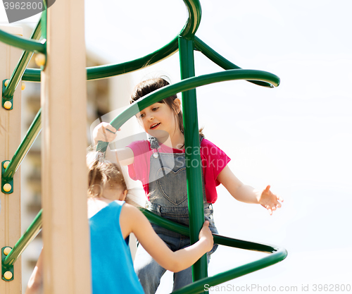 Image of group of happy little girls on children playground