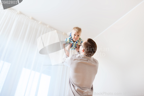 Image of father with son playing and having fun at home