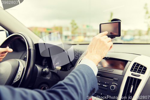 Image of close up of man with gps navigator driving car