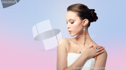 Image of beautiful woman with earring, ring and pendant