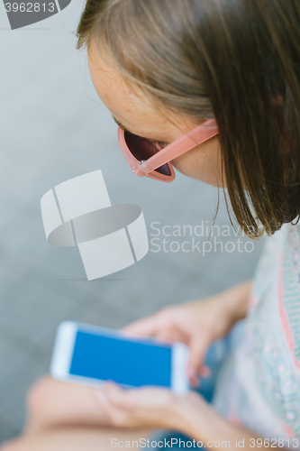 Image of woman looking at phone