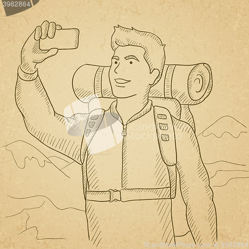 Image of Backpacker making selfie.