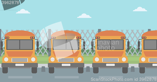 Image of Yellow buses on the background of mesh fence.