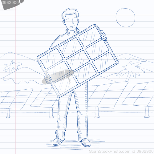 Image of Man holding solar panel.