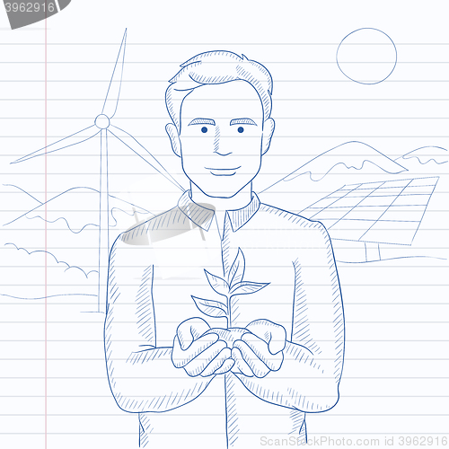 Image of Man holding plant.