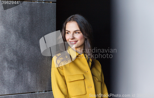 Image of smiling young woman in city