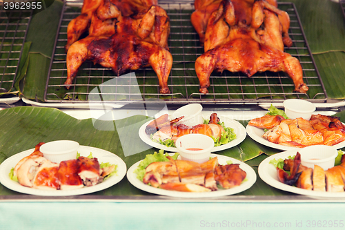 Image of grilled or fried chicken on plate at street market