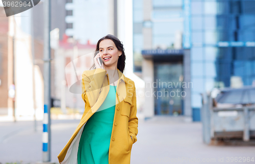 Image of smiling young woman or girl calling on smartphone