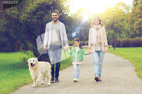 Image of happy family with labrador retriever dog in park