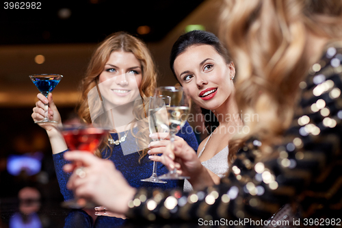 Image of happy women with drinks at night club