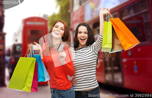 Image of teenage girls with shopping bags and credit card