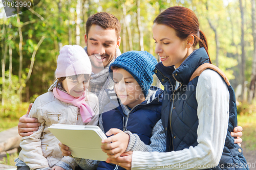 Image of happy family with tablet pc at camp