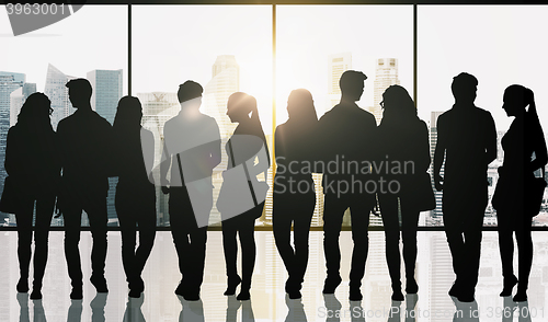 Image of people silhouettes over window and city background