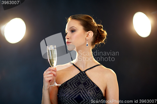 Image of young asian woman drinking champagne at party