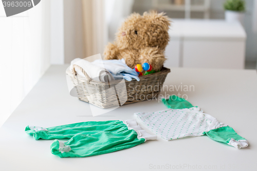 Image of close up of baby clothes set and toys for newborn