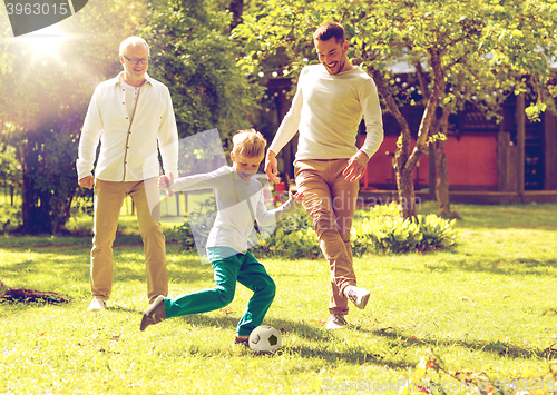 Image of happy family playing football outdoors