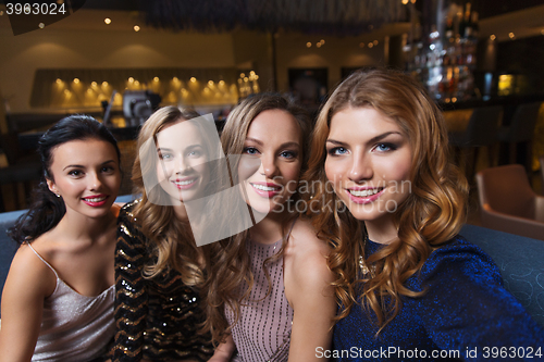 Image of happy smiling women taking selfie at night club